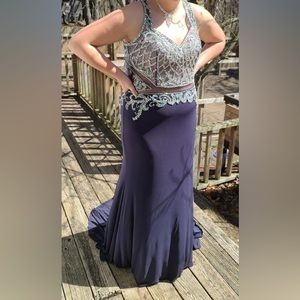 It is a 2XL in Chinese sizing. It is Dark charcoal grey, open back, with a shaw